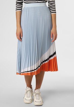 Light blue pleated midi skirt featuring vertical folds, color block design with orange, white, and black accents, worn with white sneakers.