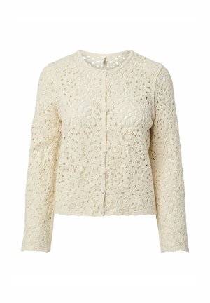 Cardigan en crochet crème à manches longues avec des motifs floraux et des boutons recouverts de tissu sur le devant.