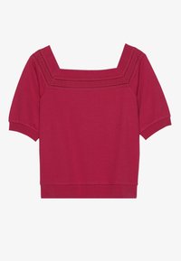Top a maniche corte, scollatura quadrata in cotone rosa profondo, caratterizzato da una fascia testurizzata con accenti perforati lungo il scollatura.