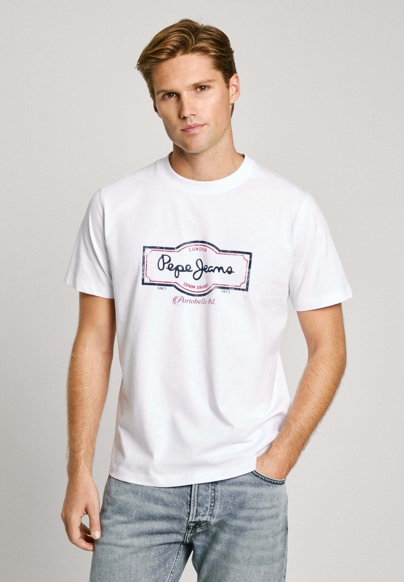White cotton t-shirt featuring a central navy and pink logo design that reads "Pepe Jeans" with a rectangular border. Short sleeves, crew neck.