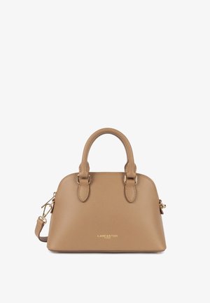 Tan textured handbag with two short handles, gold-tone hardware, logo on front, and detachable shoulder strap. Smooth finish.