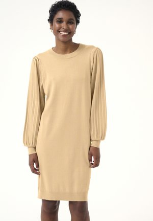 Knit beige dress with balloon sleeves, featuring ribbed texture at shoulders and cuffs. Simple, straight silhouette, knee-length design.