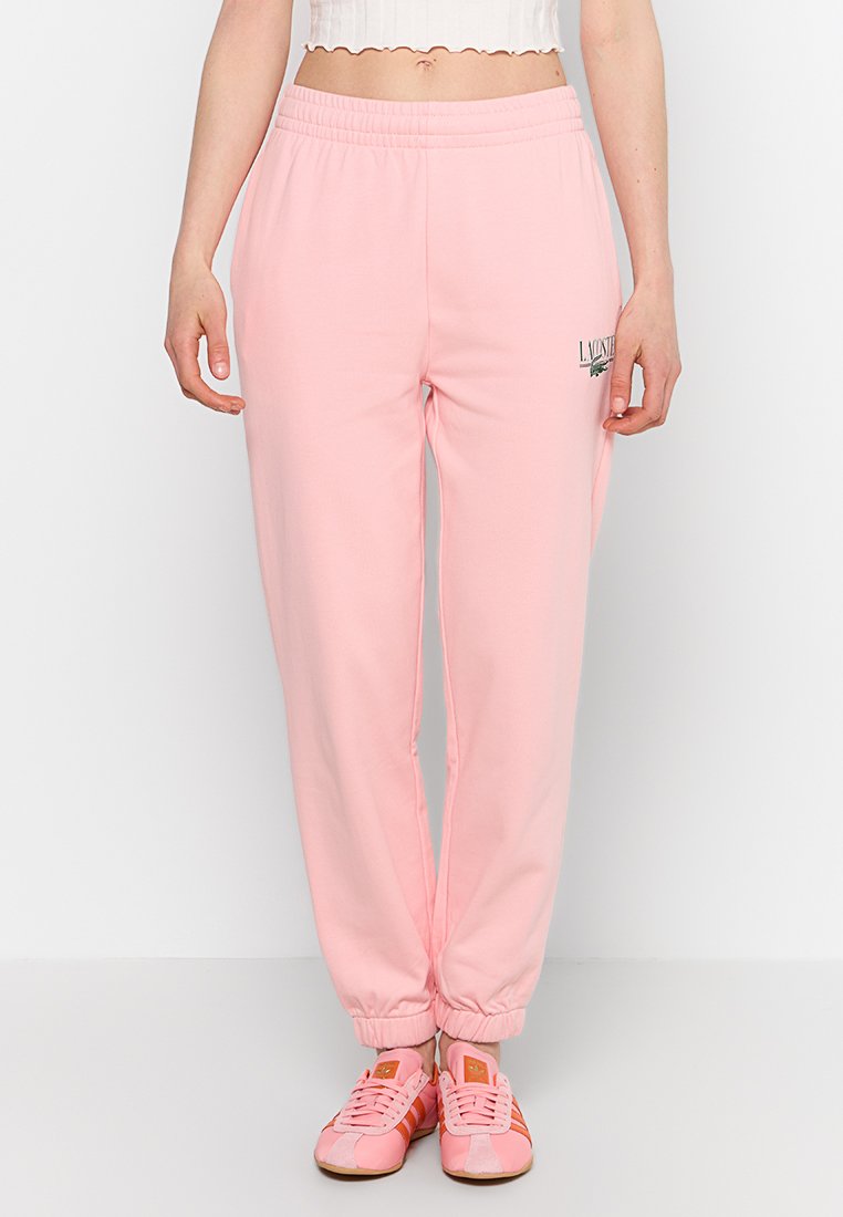 Lichtroze sweatpants van een katoenmix, met een elastische tailleband en manchetten, voorzien van een bedrukte logo op de linker dij.