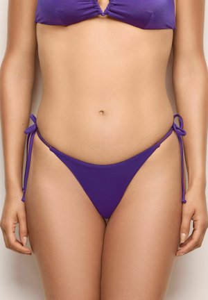 Purple bikini top with a ruched center and adjustable straps; matching purple bikini bottom with side ties and minimal coverage.