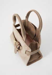 Tan suede handbag with smooth leather accents, two rounded handles, a knotted detail, and a single compartment visible inside.