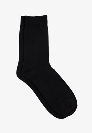 Schwarze Baumwollsocke mit glatter Textur, mittel-lang bis zur Wade, und einfachem Design mit geripptem Bund sowie verstärkten Zehen- und Fersenbereichen.