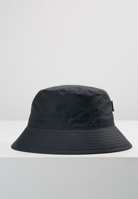 Black bucket hat made from lightweight material with a wide, flat brim and a subtle Barbour logo on the band. Smooth texture, no patterns.