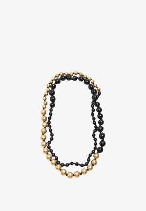 Naszyjnik z czarnymi i złotymi koralikami, składający się z różnych rozmiarów błyszczących czarnych i metalicznych złotych kul, ułożony w wielu splotach o gładkiej fakturze.