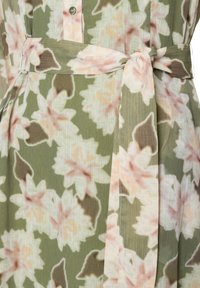 Floral dress featuring an olive green background with pink and cream flowers. Includes a matching waist tie and button closure. Textured fabric.