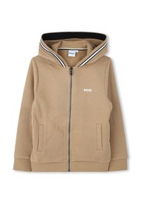 Sweat-shirt zippé à capuche beige, avec un col rayé noir et blanc, deux poches latérales et un logo sur la poitrine gauche.