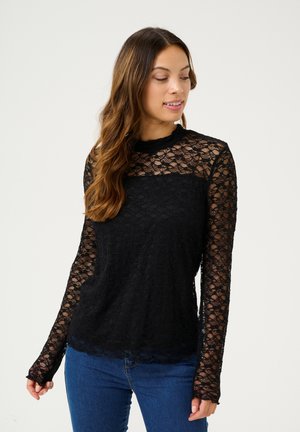 Must mustärg lühikeste varrukatega peaks, mis on valmistatud lillemustriga pitsist. Omab ühtlast musta kehaosa ja poolläbipaistvaid pitsvarrukaid. Narmastega hemline detail.
