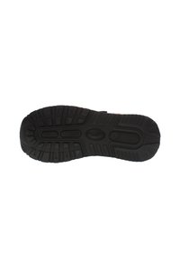 Black rubber shoe sole featuring a multi-directional tread pattern, flexible grooves, and textured surface for enhanced grip and durability.