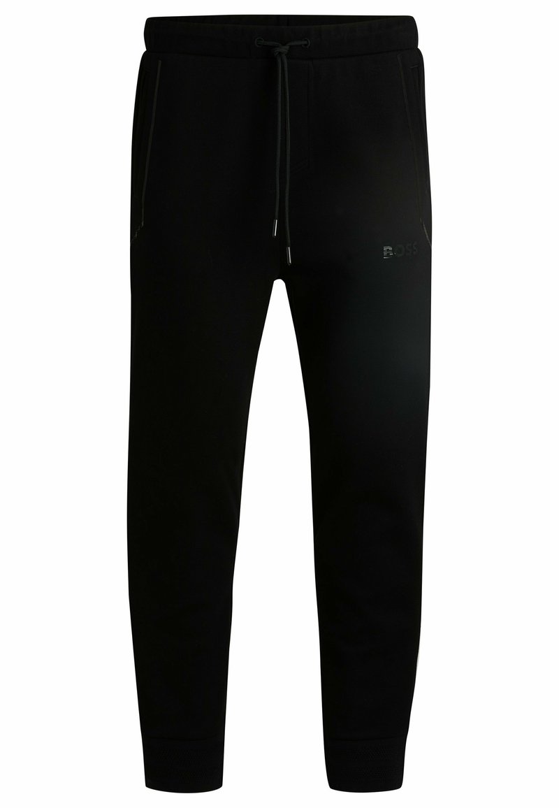 Pantalones de jogging negros ajustados con cintura elástica, cordón, bolsillos laterales, tobillos ajustados y sutil logo de Boss en el muslo derecho.