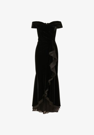 Černé sametové šaty bez ramínek s nařaseným tělem a volánkovým akcentem na levé straně. Rozšířený spodní lem a průsvitná podšívka na spodní části.