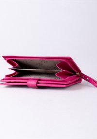 Pink leather wallet with a zip closure, featuring multiple compartments and a patterned interior lining. Rounded edges and a snap closure.