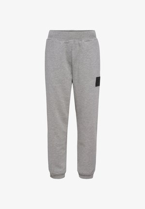 Graue Jogginghosen aus weichem Baumwollstoff, mit elastischem Bund, schmal zulaufenden Beinen und einem kleinen schwarzen Logo-Patch an der Seite.