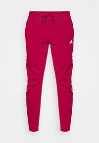 Fuchsia Sport-Jogginghosen mit elastischem Bund, Kordelzug und weißen Seitenstreifen. Mit adidas-Logo auf der Vorderseite.