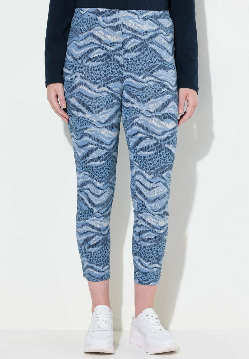 Blå mönstrade tights med vågiga och djurmotiv, tillverkade av ett mjukt material, med kort längd och elastisk midja.