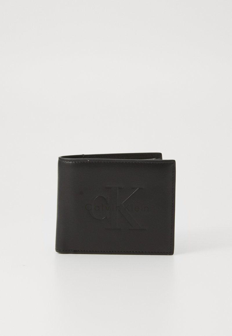 Black leather wallet featuring embossed "CK" logo, bi-fold design, clean edges, and a textured finish. Compact shape for easy carrying.
