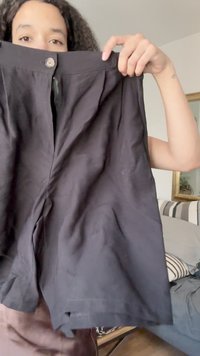Černé lněné šortky s zipovým uzavřením a jedním knoflíkem v pase. Mají volný střih s sklady v přední části.