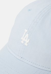 Himmelblaues Baseballcap aus Baumwolle mit strukturierter Form, das auf der Vorderseite ein weiß gesticktes "LA"-Logo trägt.