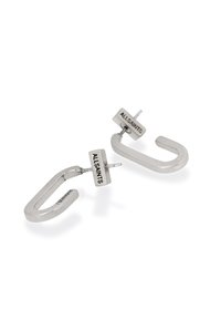 Boucles d'oreilles en métal argenté avec un design en forme de U, présentant une tige rectangulaire gravée "ALL-SAINTS". Texture lisse et forme moderne.
