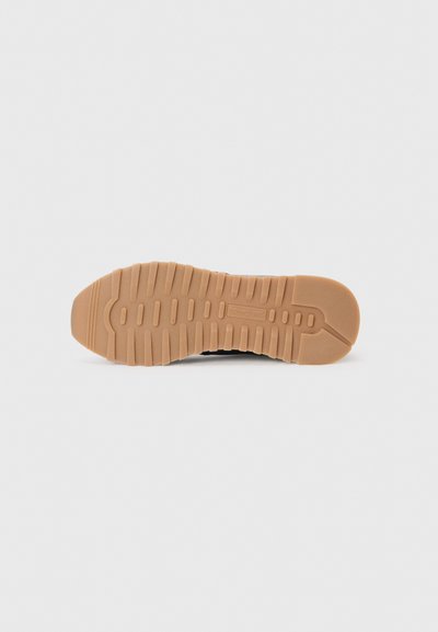 Rubber sneaker sole with textured tread pattern, featuring a light brown color with a smooth finish and molded ridges for grip.