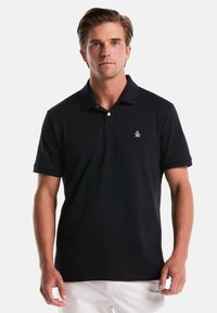 Marineblauw polo shirt met een drieknopen placket, korte mouwen en geborduurd logo op de borst. Gladde stof en klassieke pasvorm.