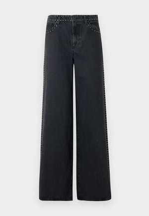 Zwarte denim jeans met wijde pijpen, voorzien van metalen studs langs de tailleband en de zijnaden. Heeft een klassieke vijfzakkenstijl en een ontspannen pasvorm.
