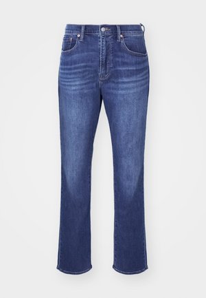 Blå denimjeans med rett ben, med fem lommer, kobbernitter og subtil falming på lårene for tekstur.