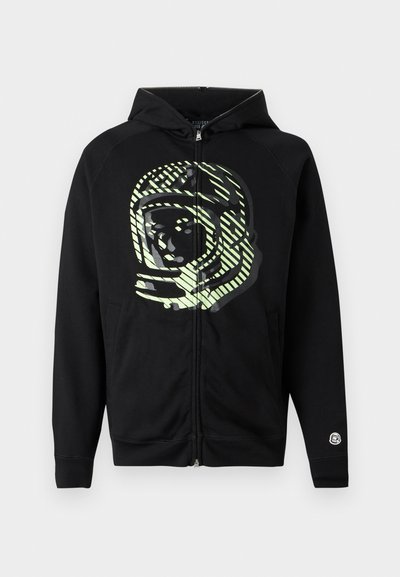 Black zip-up hoodie made of soft fabric, featuring a large astronaut graphic in light green with diagonal stripes across the chest.
