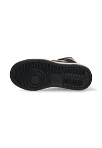 Black rubber shoe sole with textured tread pattern and circular center detail. Features deep grooves for traction and stability.