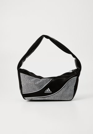 Sac à bandoulière noir Adidas avec des clous argentés scintillants et un design incurvé avec des accents blancs à l'avant.