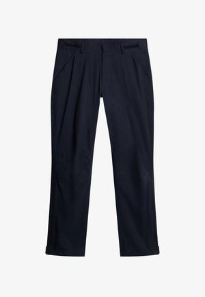 Pantaloni impermeabili blu navy con una texture liscia, dotati di tasche laterali, dettagli regolabili in vita e orli con cerniere.