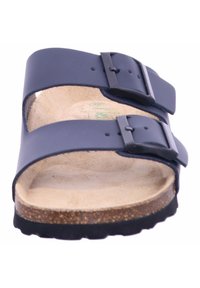 Navy blue sandals with two adjustable straps, silver buckles, a contoured cork footbed, and a textured rubber outsole.