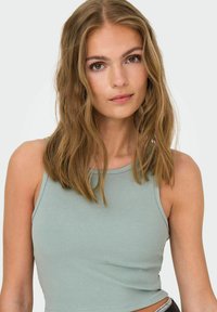 Lys grøn ribbet tanktop med rund halsudskæring og slim fit. Har smalle stropper og en blød stoftekstur.