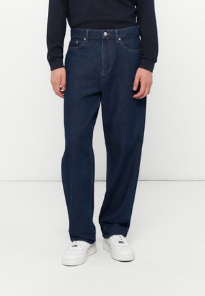 Dark blue denim jeans with a loose fit, featuring a button and zipper closure, pockets, and minimal stitching details.