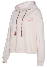 Hoodie beige chiaro realizzato in tessuto morbido, con una stampa grafica frontale con la scritta "SUNRISE PARADISE" e nappine decorative sui lacci.