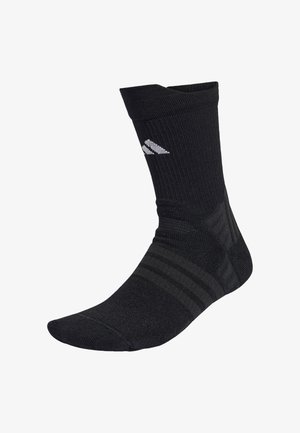 Calcetín deportivo negro con puño acanalado y pie texturizado con sutiles rayas oscuras. Logo blanco exhibido en el lateral.