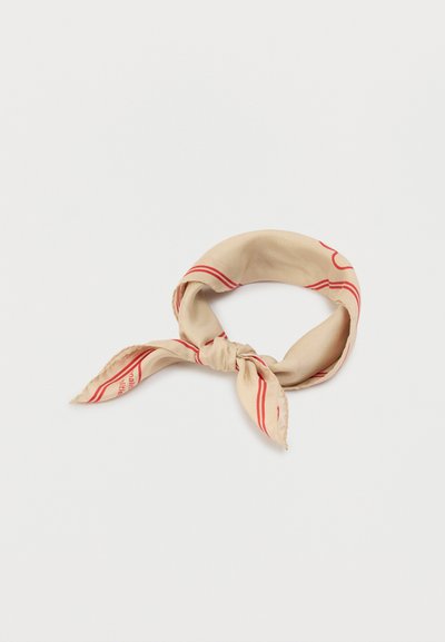 Μπεζ μεταξωτό μαντήλι με κόκκινες γραμμές, δεμένο σε κόμπο στο κέντρο. Διαθέτει λεία υφή και ορθογώνιο σχήμα, κατάλληλο για διάφορες επιλογές στυλ.