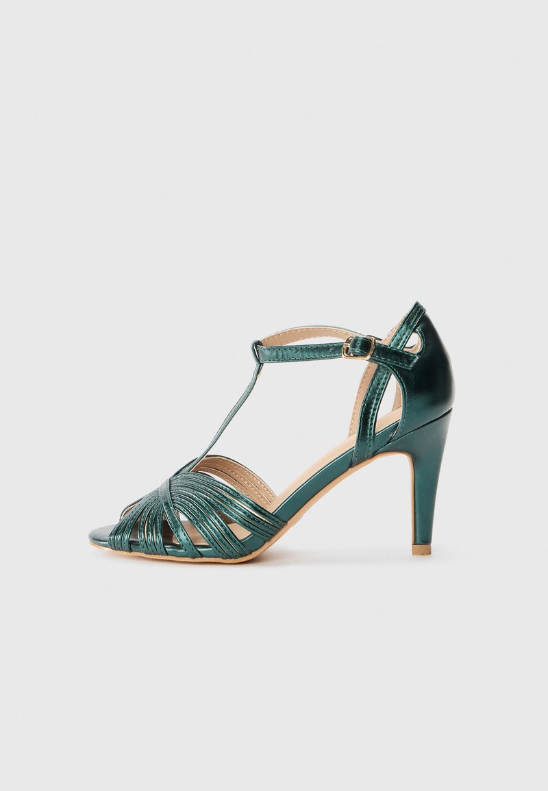 Teal high-heeled sandal with a strappy design, adjustable ankle buckle, and open toe. Features a glossy finish and a tapered heel.