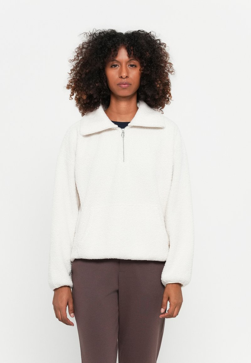 Fleece pullover in off-white, met een ritskraag, brede kraag en een relaxte pasvorm. Heeft lange mouwen en een soepele textuur.