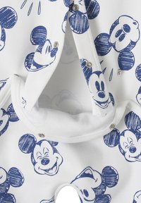 White fabric onesie featuring blue Mickey Mouse sketches. Snap closures at the bottom and along the front for easy dressing.