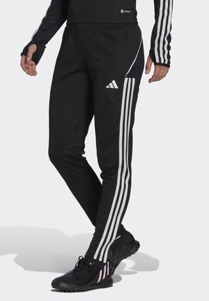 Pantalons de sport noirs avec des accents de rayures blanches sur les côtés, dotés d'une taille élastique et d'un design de jambe fuselée.
