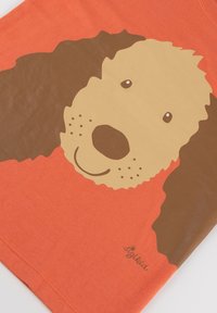 Orange cotton t-shirt featuring a large brown dog face illustration with a light brown snout and black accents.