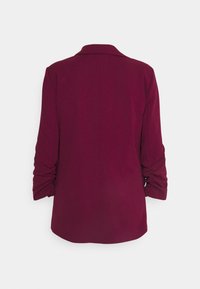 Burgundy blazer with a smooth texture, single-breasted design, and gathered sleeves; features a classic collar and seamless back.