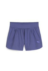 Lilla spordilad, lai kummivöö ja volditud detailidega, väikese valge Puma logoga vasakus alakulmas. Pehme kangast tekstuur.