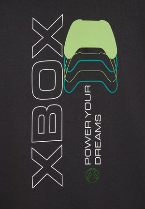 Il tessuto nero presenta un testo bianco e verde con un design del controller Xbox sopra la frase "ALIMENTA I TUOI SOGNI" e un logo Xbox verde.