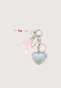 Keychain with silver heart-shaped compact mirror, translucent pink balloon dog, pink star charm, and beaded string in red, gold, and white.