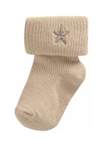 Beige stickad strumpa med en vikt mud och en ljusbrun stjärnbrodering. Har ribbad struktur och en rund tådesign.